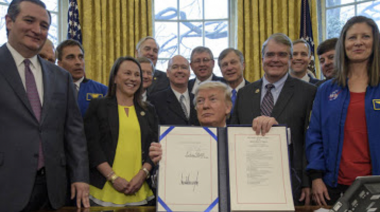Donald Trump posa junto a la norma que aumenta el financiamiento a la NASA.  Foto: NASA