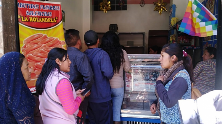 Un grupo de personas hace fila para comprar embutidos en el mercado Garita de Lima. Foto: ANF.
